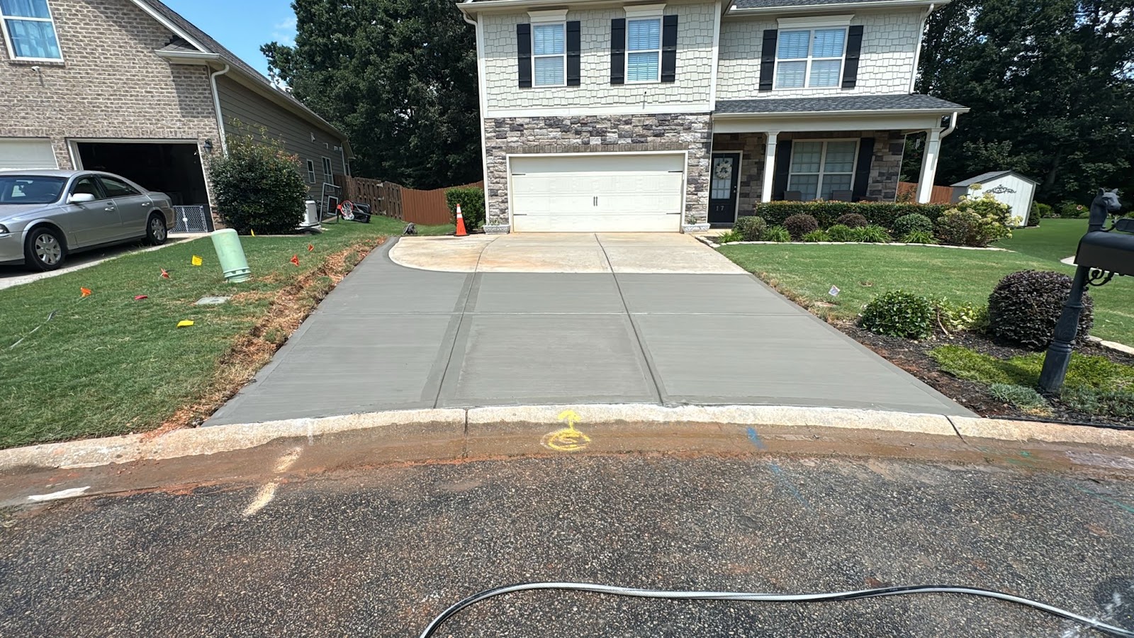 Freshly finished residential concrete driveway installed by Prime Concrete Solutions